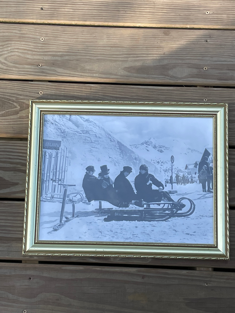 A framed black and white photograph of Beatles on a sled in a snowy landscape, for the movie, Help.