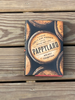 A hardcover book titled 'Pappyland' by Wright Thompso featuring a rustic barrel graphic design, resting on a weathered wooden plank surface.