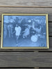 A framed black and white photograph of a group of people, including jazz band on hand for Sugar Ray Robinson's workout. 1949.